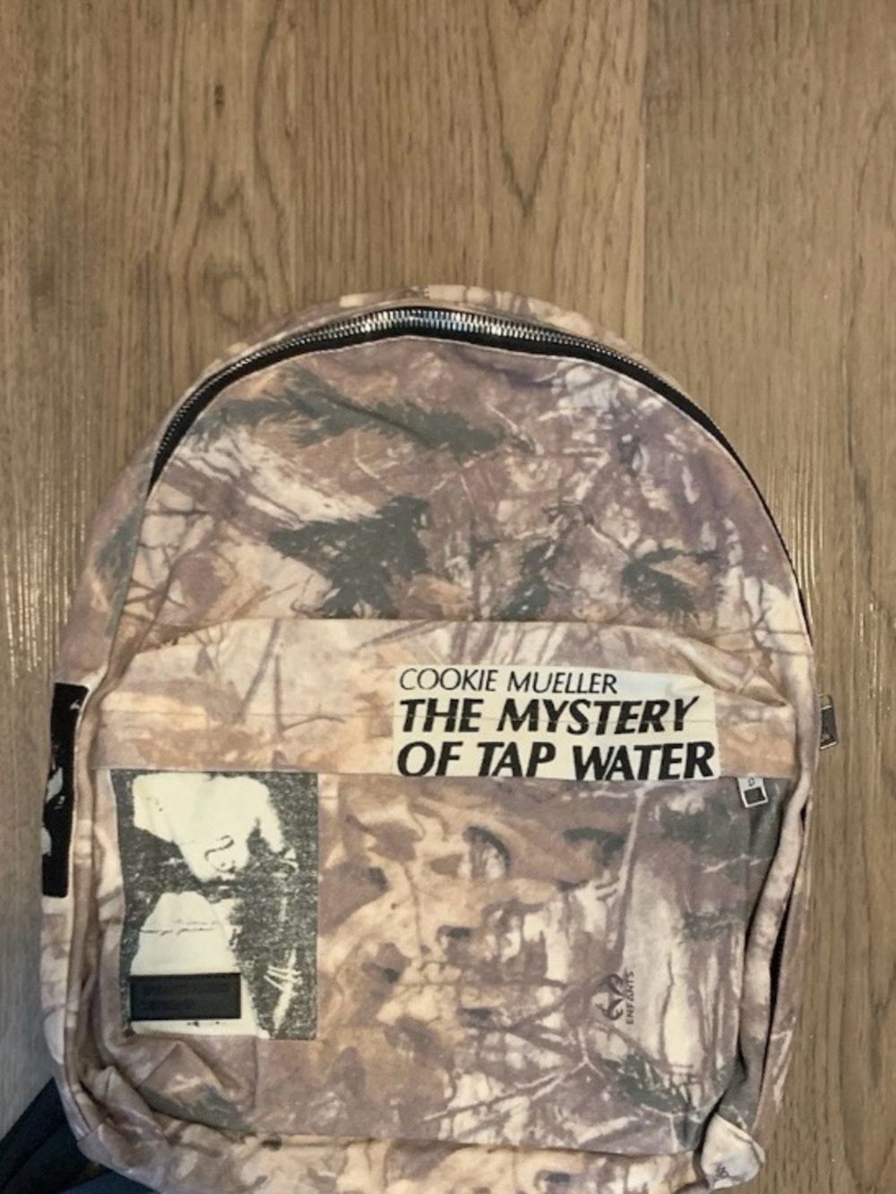 'The Mystery of Tap Water' Beige Camouflage Backpack
